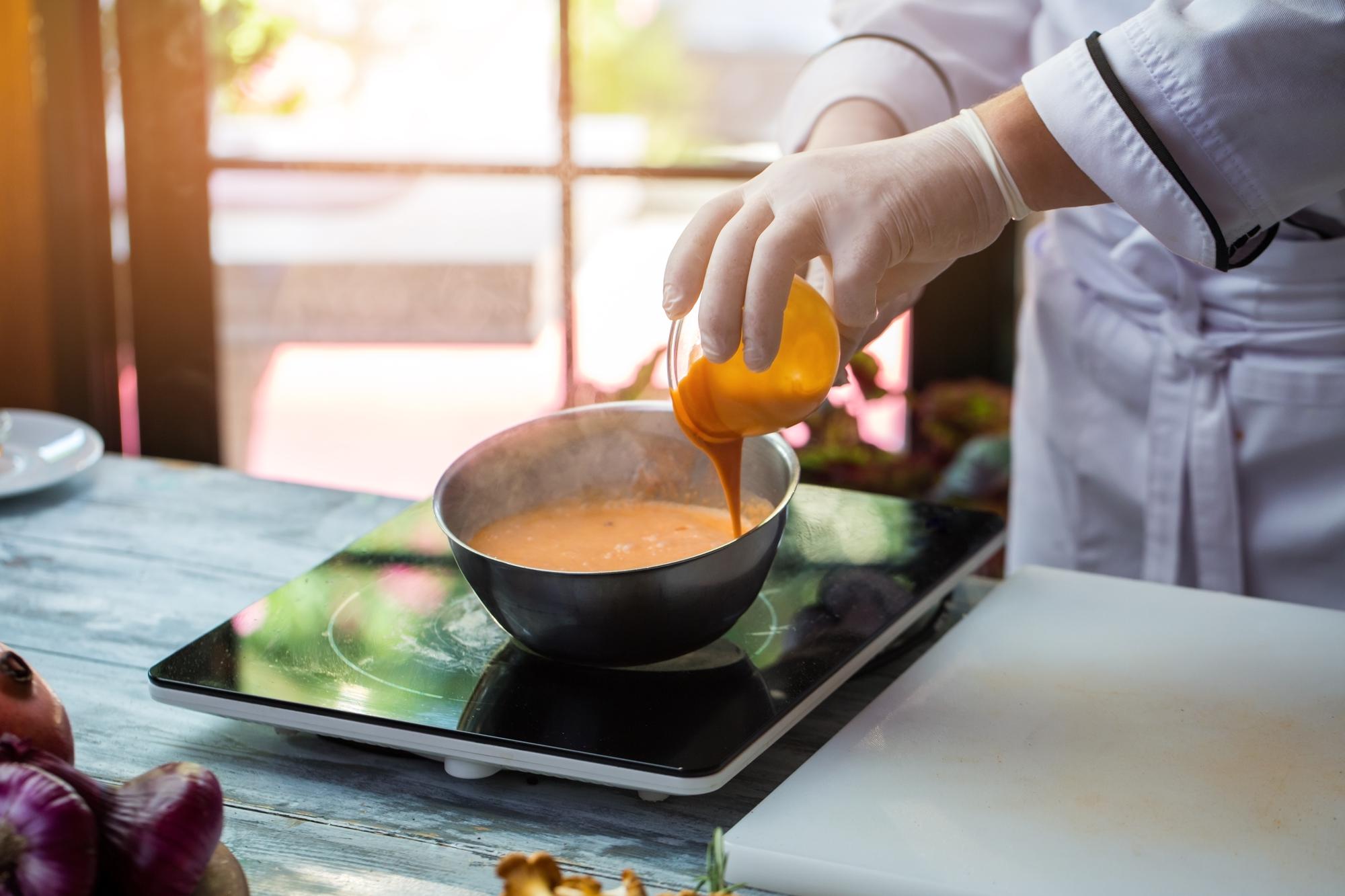 Sauce being reduced in a copper pan